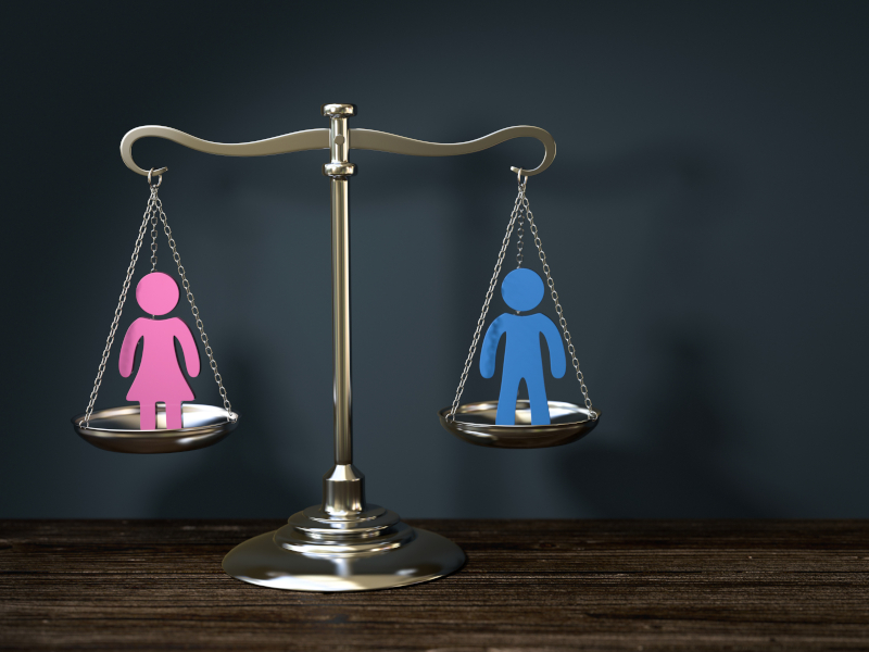 Ein weibliches und ein männliches Piktogramm auf Waage